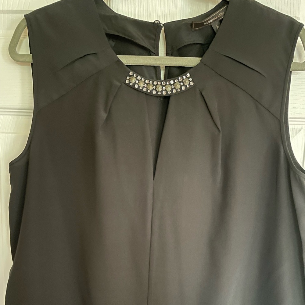 BCBG black “Lauren” sleeveless blouse.  New with tags.  Size Large